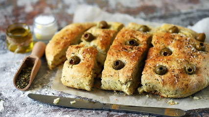 Traditional italian bread with olives and spices. Focaccia.