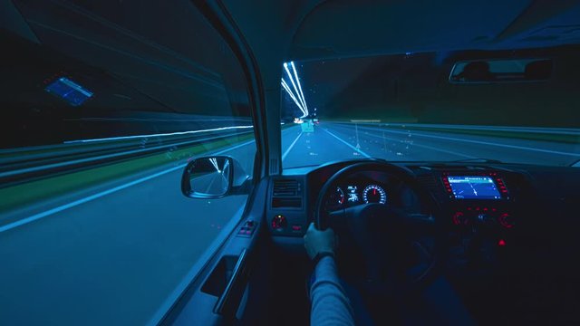 The man driving a car with virtual navigator at the night city road. hyperlapse