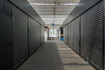 Inner perspective view at corridor of empty and closed stall without people in farmer market in Düsseldorf, Germany, during epidemic of COVID-19 virus in Europe. 