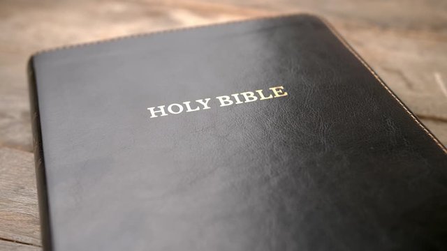 Holy Bible on wooden background, closeup