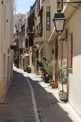 Typical Greek narrow alley with plants and moterbikes, Rethymno, Crete, Greece