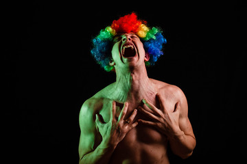 Crazy clown with an ax. Clown with an ax. Crazy. Psycho. Crazy man with an ax on a black background.