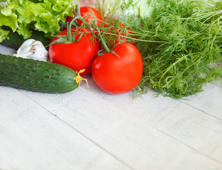 Fresh vegetables tomatoes cucumbers dill salad on a white background.