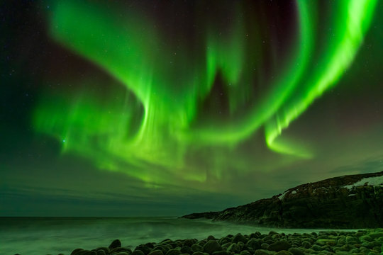 Northern Lights on the shore of the Arctic Ocean.
