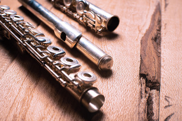 Close up transverse flute on wooden background. Classical music concept. Funk culture and music concept. topical orchestra and melody. Copy space