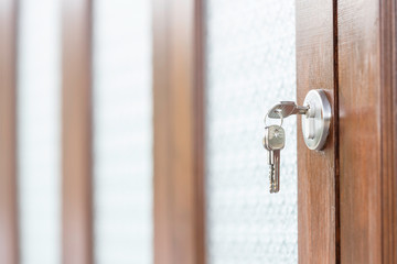 The key that is plugged in the keyhole on the glass door.