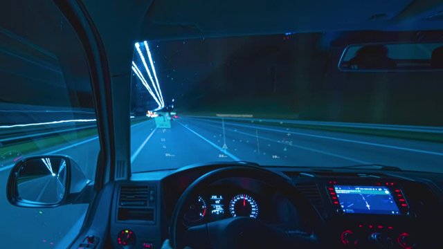 The man driving a car with virtual gps at the night city highway. hyperlapse