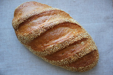 bread with sesame seeds. fresh bread on a wooden table. homemade bread with sesame seeds