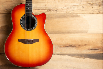 Acoustic guitar top view on wooden background. Country music concept. Folk and funk music concept....