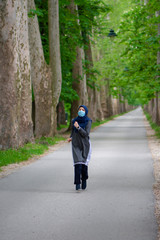 Young muslim runner wearing face mask in nature