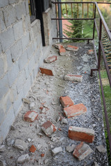 Scattered and damaged bricks on the balcony