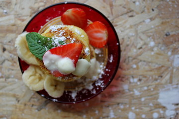 strawberry and cream. Cottage cheese pancakes cottage cheese with strawberry, mint, and banana. Ukrainian traditional food. Ukrainian national kitchen.