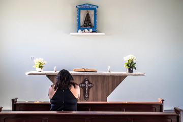 Garca, Sao Paulo, Brazil, November 19, 2019. Woman prays inside a chapel in the rural area of Garça