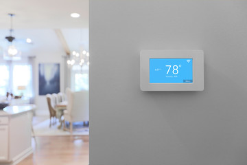 Home with smart thermostat mounted on wall with touchscreen  - obrazy, fototapety, plakaty
