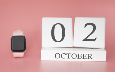 Modern Watch with cube calendar and date 02 october on pink background. Concept autumn time vacation.