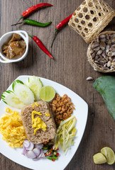 shrimp paste rice with caramelized pork condiment, dried shrimp, green mango, chilies, lime, shallot , cucumber. thai food called kao Kluk Kapi.top view. Flat lay.