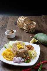 shrimp paste rice with caramelized pork condiment, dried shrimp, green mango, chilies, lime, shallot , cucumber. thai food called kao Kluk Kapi.