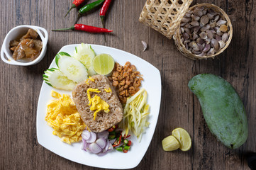 shrimp paste rice with caramelized pork condiment, dried shrimp, green mango, chilies, lime, shallot , cucumber. thai food called kao Kluk Kapi.top view. Flat lay.