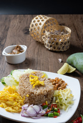 shrimp paste rice with caramelized pork condiment, dried shrimp, green mango, chilies, lime, shallot , cucumber. thai food called kao Kluk Kapi.