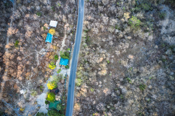 This unique photo shows the rustic autumn landscape of Hua Hin. A country road leads through this scenario. The picture is a drone photo! recorded in one evening!