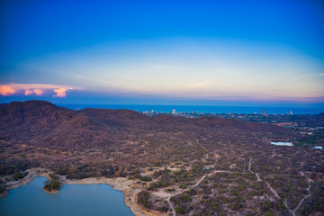 This unique photo shows the back landscape of Hua Hin in Thailand with a sunset in the background you can see the city located by the sea!
