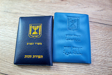 Passports Israel non biometric and biometric on a wooden background (passport Israeli booklet,...