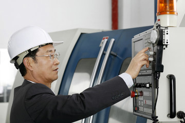 Businessman controlling a machine