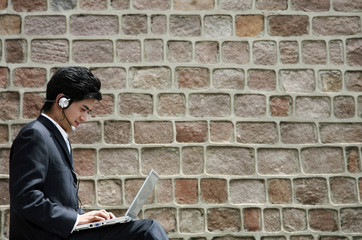 Businessman with headphones using laptop