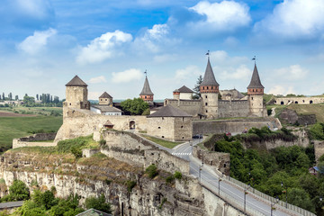 Fototapeta na wymiar Old former Ruthenian-Lithuanian medieval castle located in the historic city of Kamianets-Podilskyi, Ukraine. Dominate over the surrounding Smotrych River canyon landscape
