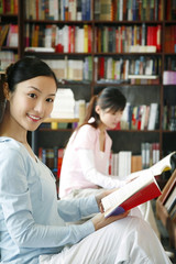 Students reading books in library