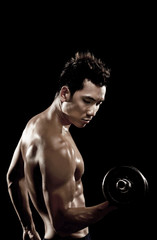 Fototapeta na wymiar Muscular man lifting dumbbell