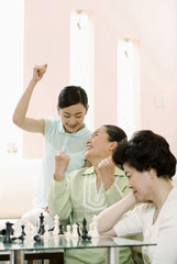 Fototapeta premium Women celebrating after winning the chess game