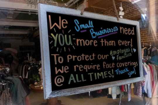 Sign On Small Business Re-opening After Covid 19 Requiring A Face Mask