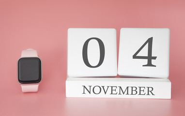 Modern Watch with cube calendar and date 04 november on pink background. Concept autumn time vacation.