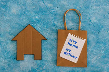 restaurant takeaway shopping bags with house icon and Stay Home We Deliver message.