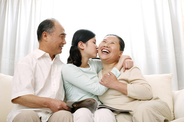 Fototapeta premium Woman giving senior woman a peck on the cheek