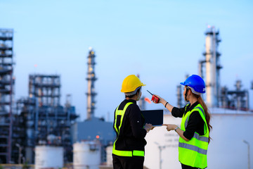 Smart two female engineer discussion together at refinery industry plant at industry factory center area. Engineering Concept