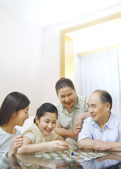 Family playing board game together