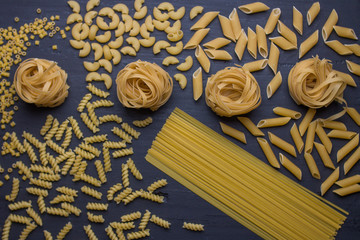 variety of noodles on black background