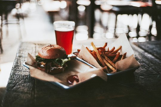 Hamburger and fries with a beer