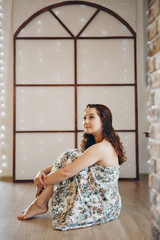 Fototapeta premium the girl is sitting on the chairs. spending time in self-isolation. interior decoration
