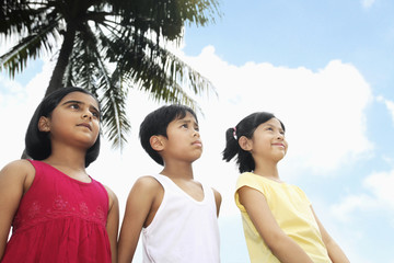 Children standing in a row and looking away