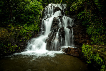 Waterfall landscape. Beautiful hidden Jembong waterfall in tropical rainforest in Ambengan, Bali. Slow shutter speed, motion photography.