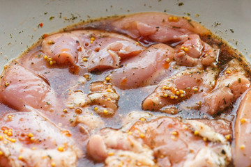 Chicken fillet in marinade with different spices in its own juice.