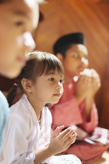 Children saying prayer
