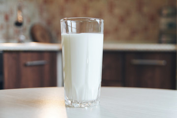 Glass of milk. Pouring milk in a transparent glass