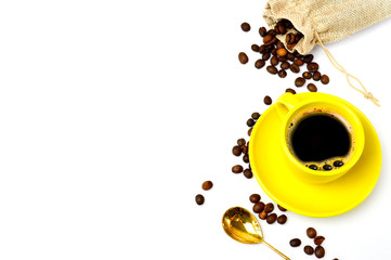yellow cup of coffee on a white background with coffee grains. Morning coffee top view. Place for text. Flat lay, copy space