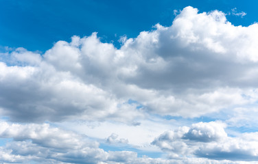 Naklejka na ściany i meble White clouds on the blue sky. Fluffy clouds background