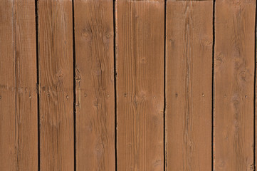 old wooden fence painted with brown paint close up