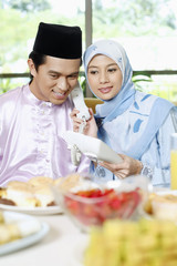 Man and woman answering phone call together